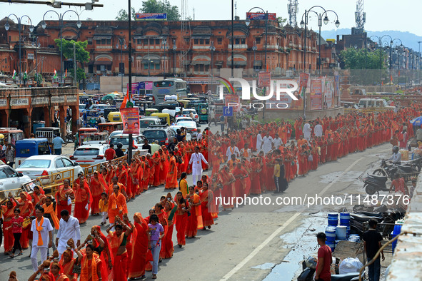 Hindu women devotees are carrying holy water as they take part in a 'Kalash Yatra' during the holy month of 'Sharvan', in Jaipur, Rajasthan,...