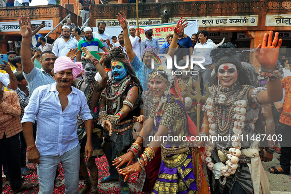 Artists are dressing up and performing during the 'Kalash Yatra' in the holy month of 'Sharvan', in Jaipur, Rajasthan, India, on August 17,...