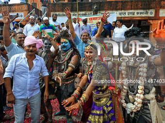 Artists are dressing up and performing during the 'Kalash Yatra' in the holy month of 'Sharvan', in Jaipur, Rajasthan, India, on August 17,...