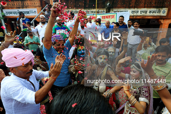 Artists are dressing up and performing during the 'Kalash Yatra' in the holy month of 'Sharvan', in Jaipur, Rajasthan, India, on August 17,...