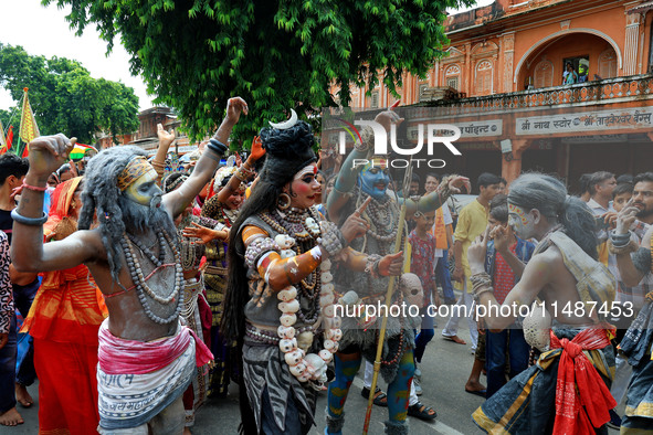 Artists are dressing up and performing during the 'Kalash Yatra' in the holy month of 'Sharvan', in Jaipur, Rajasthan, India, on August 17,...