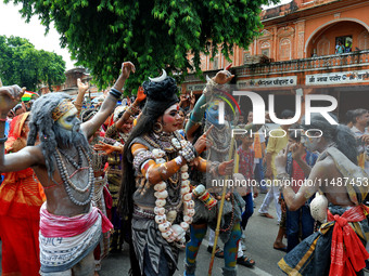 Artists are dressing up and performing during the 'Kalash Yatra' in the holy month of 'Sharvan', in Jaipur, Rajasthan, India, on August 17,...