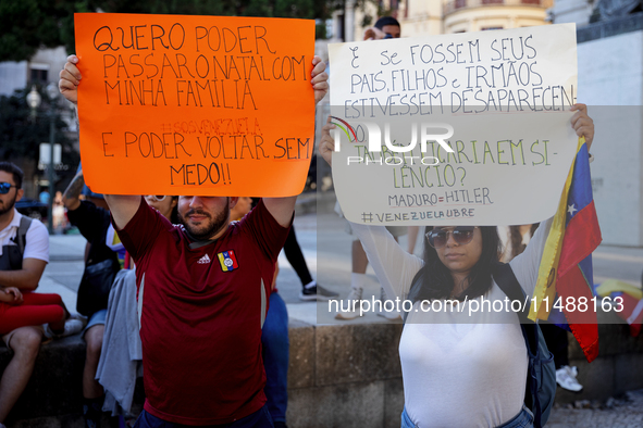 People take part in a protest called by the Venezuelan opposition for election 'victory' to be recognised in Porto, Portugal, on August 17,...