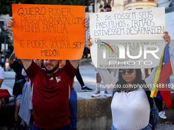 People take part in a protest called by the Venezuelan opposition for election 'victory' to be recognised in Porto, Portugal, on August 17,...