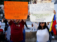 People take part in a protest called by the Venezuelan opposition for election 'victory' to be recognised in Porto, Portugal, on August 17,...