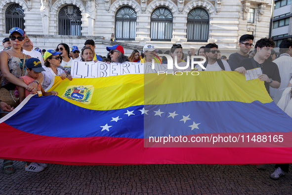 People take part in a protest called by the Venezuelan opposition for election 'victory' to be recognised in Porto, Portugal, on August 17,...