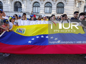 People take part in a protest called by the Venezuelan opposition for election 'victory' to be recognised in Porto, Portugal, on August 17,...