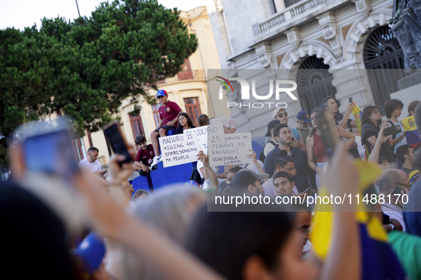 People take part in a protest called by the Venezuelan opposition for election 'victory' to be recognised in Porto, Portugal, on August 17,...