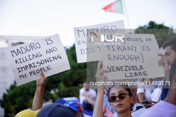 People take part in a protest called by the Venezuelan opposition for election 'victory' to be recognised in Porto, Portugal, on August 17,...