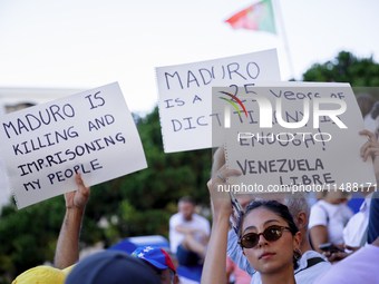 People take part in a protest called by the Venezuelan opposition for election 'victory' to be recognised in Porto, Portugal, on August 17,...