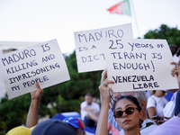 People take part in a protest called by the Venezuelan opposition for election 'victory' to be recognised in Porto, Portugal, on August 17,...