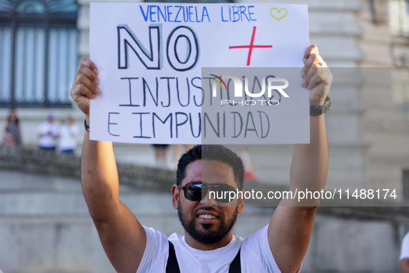 People take part in a protest called by the Venezuelan opposition for election 'victory' to be recognised in Porto, Portugal, on August 17,...