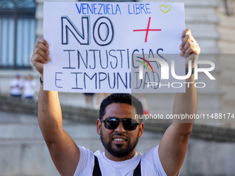 People take part in a protest called by the Venezuelan opposition for election 'victory' to be recognised in Porto, Portugal, on August 17,...