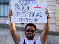 People take part in a protest called by the Venezuelan opposition for election 'victory' to be recognised in Porto, Portugal, on August 17,...