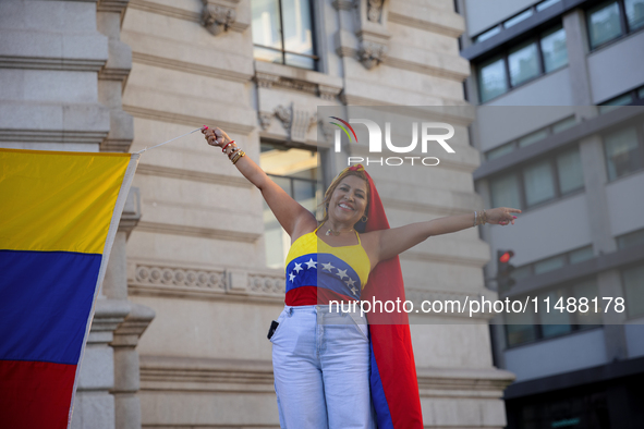 People take part in a protest called by the Venezuelan opposition for election 'victory' to be recognised in Porto, Portugal, on August 17,...