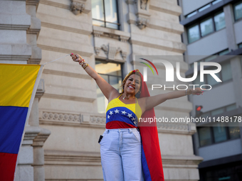 People take part in a protest called by the Venezuelan opposition for election 'victory' to be recognised in Porto, Portugal, on August 17,...