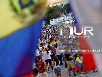 People take part in a protest called by the Venezuelan opposition for election 'victory' to be recognised in Porto, Portugal, on August 17,...