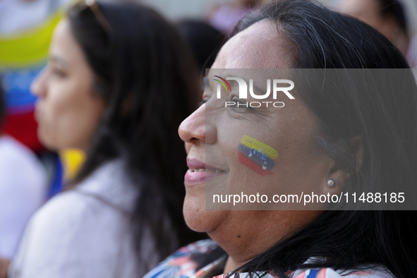 People take part in a protest called by the Venezuelan opposition for election 'victory' to be recognised in Porto, Portugal, on August 17,...