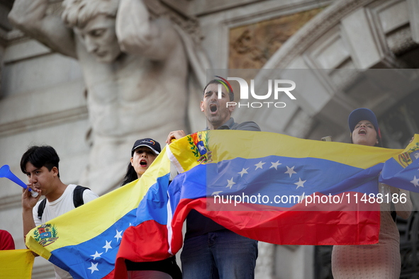 People take part in a protest called by the Venezuelan opposition for election 'victory' to be recognised in Porto, Portugal, on August 17,...