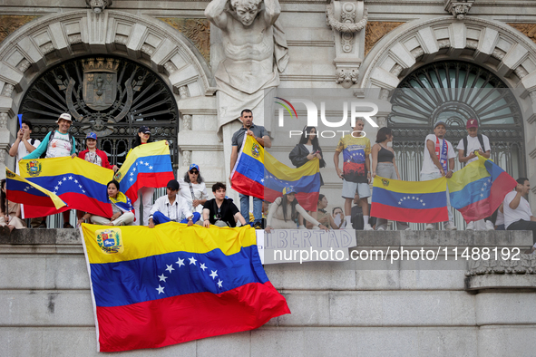 People take part in a protest called by the Venezuelan opposition for election 'victory' to be recognised in Porto, Portugal, on August 17,...