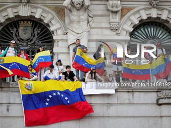 People take part in a protest called by the Venezuelan opposition for election 'victory' to be recognised in Porto, Portugal, on August 17,...