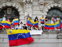 People take part in a protest called by the Venezuelan opposition for election 'victory' to be recognised in Porto, Portugal, on August 17,...