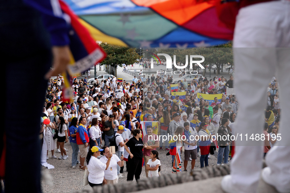 People take part in a protest called by the Venezuelan opposition for election 'victory' to be recognised in Porto, Portugal, on August 17,...