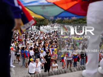 People take part in a protest called by the Venezuelan opposition for election 'victory' to be recognised in Porto, Portugal, on August 17,...