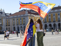 People are holding the Venezuelan flag and protesting the recent election results in Venezuela during a rally at Commerce Square in Lisbon,...