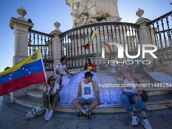 People are holding the voting report ''Actas'' during a rally at Commerce Square in Lisbon, Portugal, on August 17, 2024. Opponents to the r...