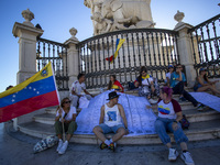 People are holding the voting report ''Actas'' during a rally at Commerce Square in Lisbon, Portugal, on August 17, 2024. Opponents to the r...