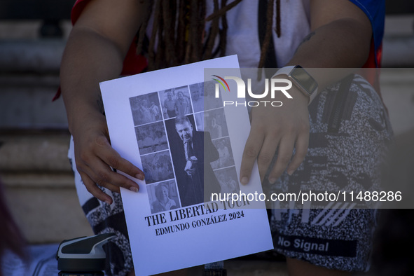 A person is holding a banner during a rally at Commerce Square in Lisbon, Portugal, on August 17, 2024. Opponents to the regime of Venezuela...