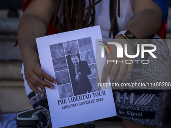 A person is holding a banner during a rally at Commerce Square in Lisbon, Portugal, on August 17, 2024. Opponents to the regime of Venezuela...