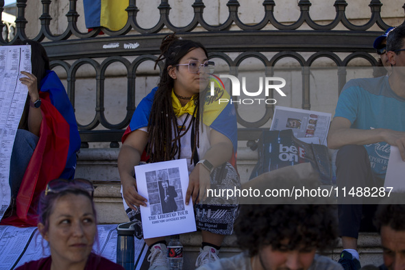 A person is holding a banner during a rally at Commerce Square in Lisbon, Portugal, on August 17, 2024. Opponents to the regime of Venezuela...