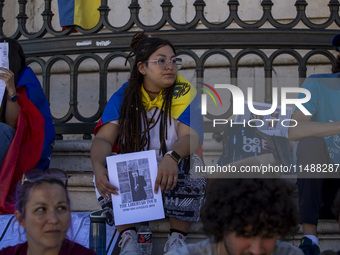 A person is holding a banner during a rally at Commerce Square in Lisbon, Portugal, on August 17, 2024. Opponents to the regime of Venezuela...