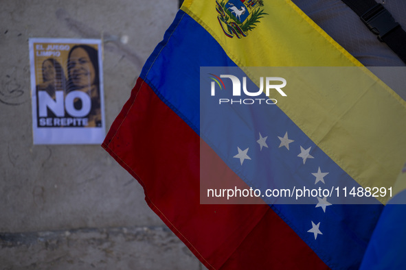 A person is holding a Venezuelan flag during a rally in Lisbon, Portugal, on August 17, 2024, at Commerce Square. Opponents to the regime of...