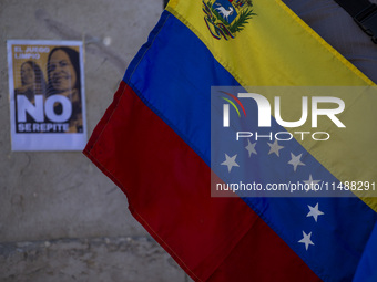 A person is holding a Venezuelan flag during a rally in Lisbon, Portugal, on August 17, 2024, at Commerce Square. Opponents to the regime of...