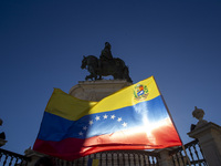 A person is holding a Venezuelan flag during a rally at Commerce Square in Lisbon, Portugal, on August 17, 2024. Opponents to the regime of...