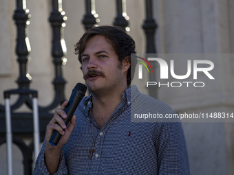 A person is talking with a microphone during a rally at Commerce Square in Lisbon, Portugal, on August 17, 2024. Opponents to the regime of...