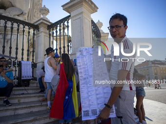 A person is holding the voting reports ''Actas'' during a rally at Commerce Square in Lisbon, Portugal, on August 17, 2024. Opponents to the...