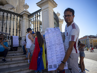 A person is holding the voting reports ''Actas'' during a rally at Commerce Square in Lisbon, Portugal, on August 17, 2024. Opponents to the...