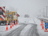 A road is being closed with a stop sign during heavy snowfall in Springfield, in the Selwyn District of Canterbury, in the South Island, New...