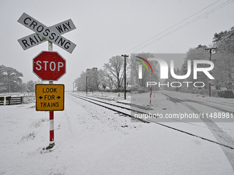 A snow-covered road and a railway track are being seen during heavy snowfall in Springfield, in the Selwyn District of Canterbury, in the So...