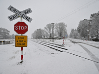 A snow-covered road and a railway track are being seen during heavy snowfall in Springfield, in the Selwyn District of Canterbury, in the So...