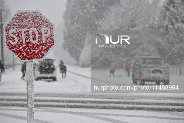 A road sign is being covered with snow during heavy snowfall in Springfield, in the Selwyn District of Canterbury, in the South Island, New...