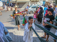 Young followers of a Sufi order are carrying Sufi flags as they are preparing for the start of the annual procession of Sidi Bou Said in Ari...