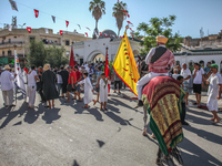 A devotee from a Sufi order in traditional Tunisian dress is representing the city's patron saint on horseback and leading the annual proces...