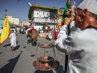 A devotee from a Sufi order in traditional Tunisian dress is representing the city's patron saint on horseback and leading the annual proces...