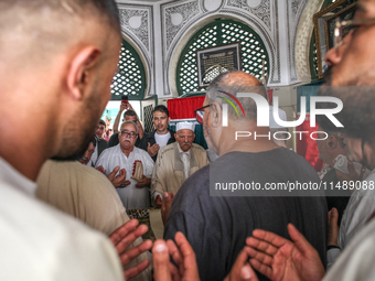 Devotees, leaders of a Sufi order, and local residents are reciting some suras from the holy book of Islam, the Koran (Qur'an), at the mauso...