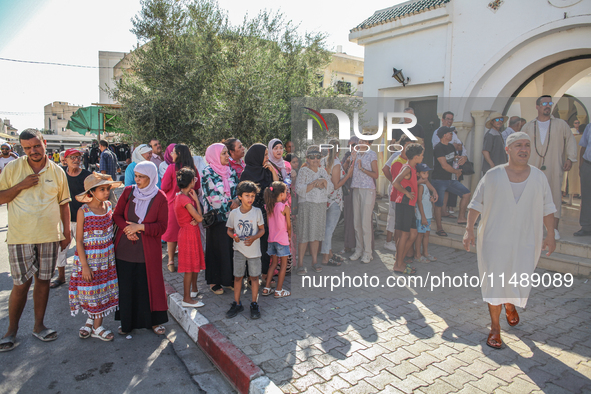 Women, devotees of a Sufi order, and local residents are waiting for the start of the annual procession of Sidi Bou Said outside the mausole...